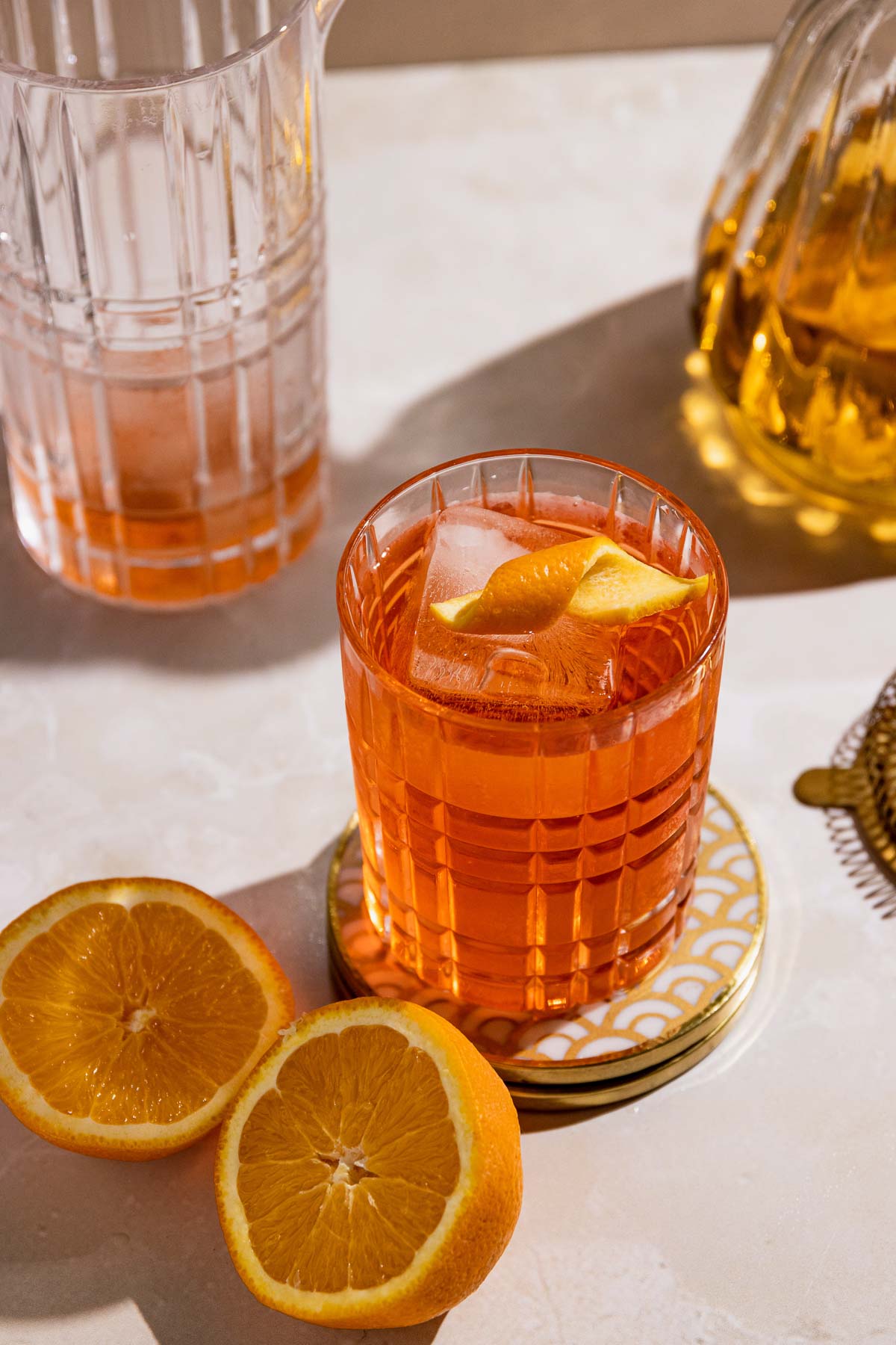 Negroni drink in a highball glass with orange twist.