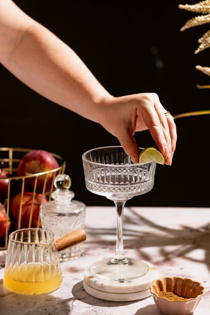 Hand sliding a lime of the rim of a glass.