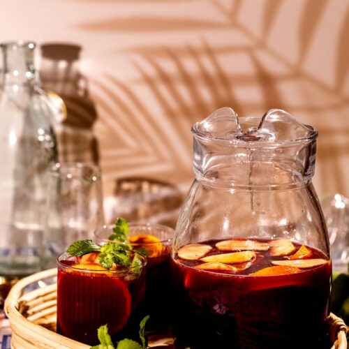 Pitcher of classic red wine sangria with fruit floating in it.