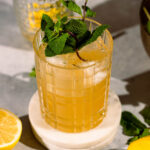 Close up of fresh mint garnish in a whiskey cocktail.