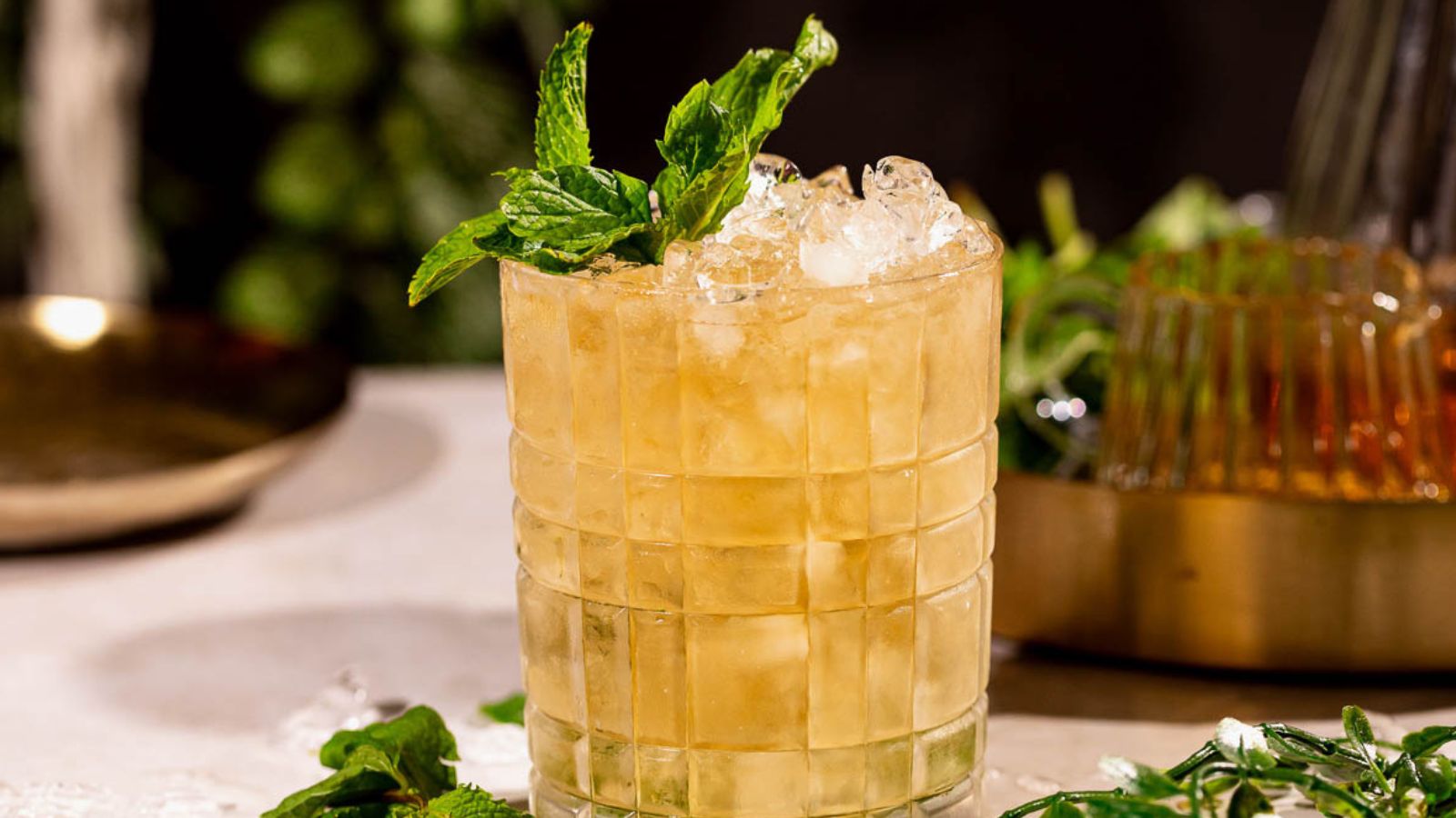 Minty bourbon cocktail over crushed ice.