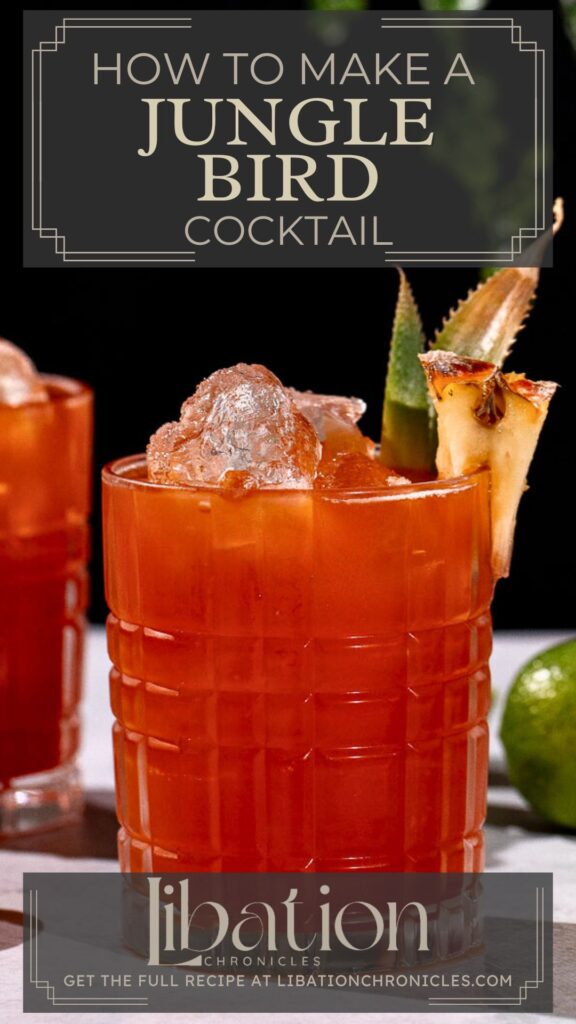 A glass of red Jungle Bird cocktail with ice, garnished with pineapple and a green leaf, sits beside a lime on a table with a cocktail recipe website text overlay.